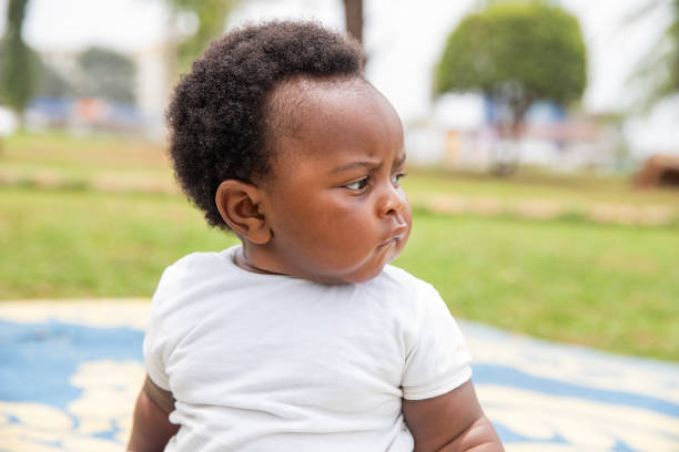 istock An African child looks to the side, curious and thoughtful expression 1574252842