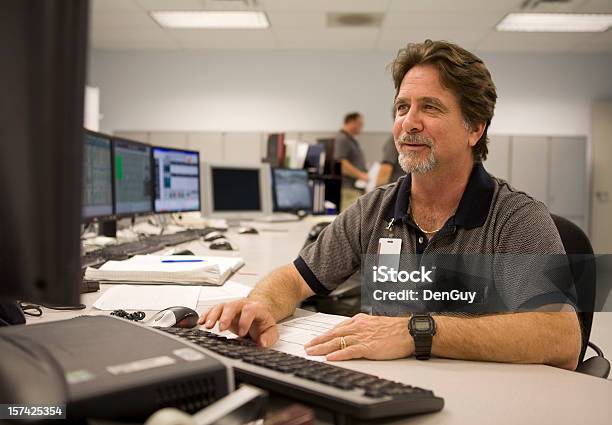 Control Room Operator Working At Computer Stock Photo - Download Image Now - Control Room, Sewage Treatment Plant, Occupation