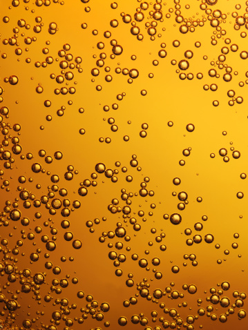 Close-up shot of carbonation bubbles. Cola, beer or amber colored drink.  Top 1/8 bubbles are slightly soft. Shot with 22 megapixel back on medium format camera.