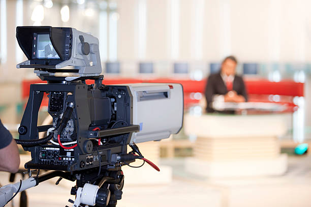 istock Newsreader in front of television camera 157425443