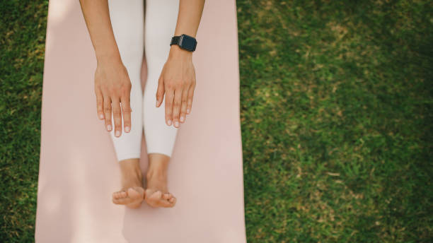 istock Woman having stretching exercise on yoga class in a park. 1574254931