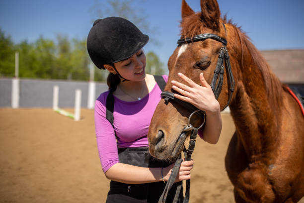 istock Girl with her horse 1574254936