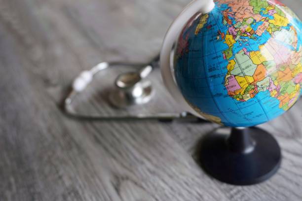 istock Selective focus image of stethoscope and world globe with copy space. 1574259001
