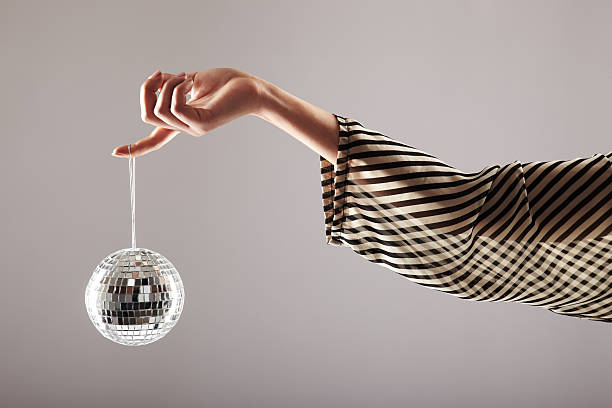 istock Small disco ball dangling from woman's finger 157426803