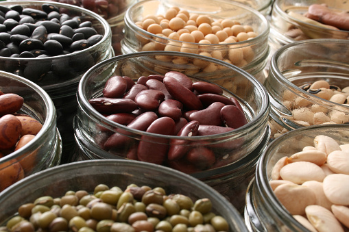 Variety of beans inside jars. Shallow depth of field