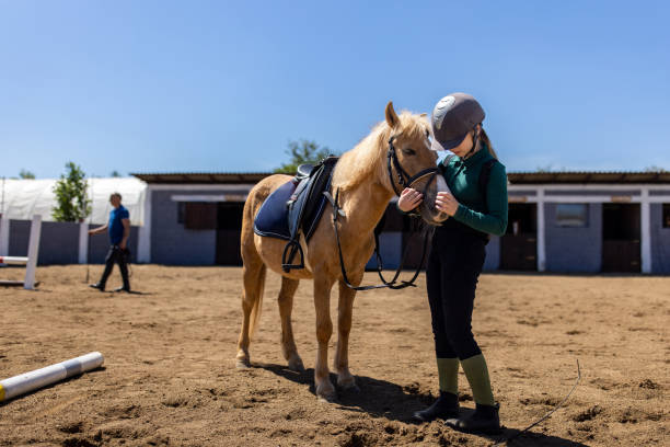 istock Girl with her horse 1574272663