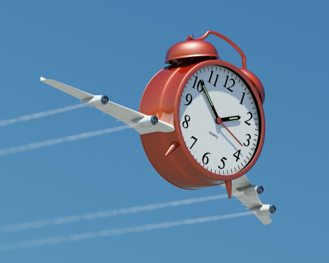 A clock with jet wings flying across a blue sky. Very detailed high resolution 3D render.