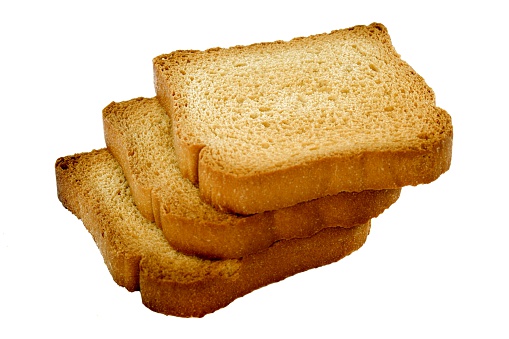 three slices of a light, dry biscuit or piece of twice-baked bread, especially one prepared for use as baby food on white background