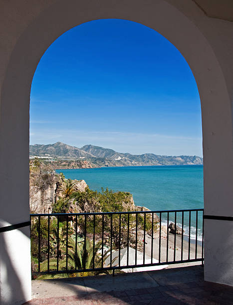 The Mediterranian Sea Through White Arches A view of the blue and green colors of the Mediterranian Sea through the white arches on a large terrace... Nerja , Spain. nerja stock pictures, royalty-free photos & images