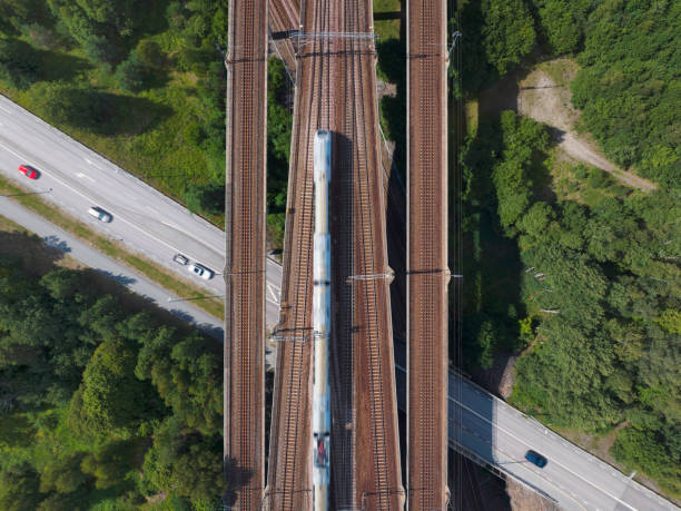 istock Train on a railway bridge above a road with traffic 1574279535