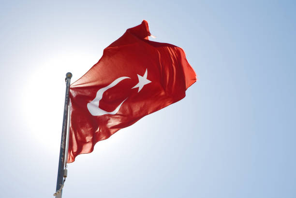 Izmir, Turkey - September 9, 2022: Close up shot of Turkish flags in a crowded people at the celebrations of liberation day Izmir Turkey at the Republic square.