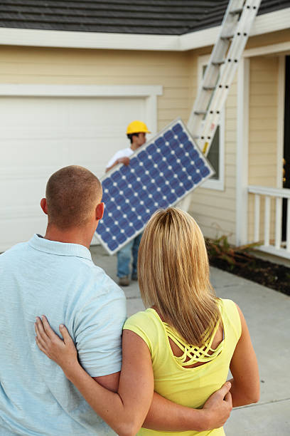 Homeowners Getting A Solar Electric System  gchutka stock pictures, royalty-free photos & images
