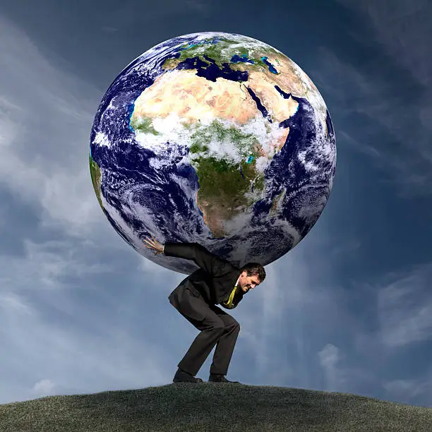 Conceptual royalty free stock image of a businessman as Atlas with the world on his shoulders. African continent version - see my portfolio for variations.