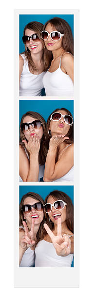 Friends In A Photo Booth Two women posing in a photo booth. passport photos stock pictures, royalty-free photos & images