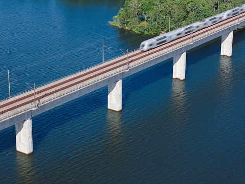 A train crossing a bridge on a summer day in the Uppland region of Sweden.