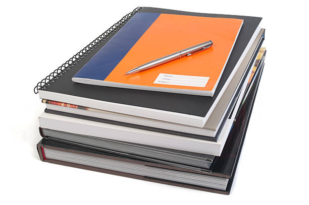 Reference books, notebooks and pen stock photo