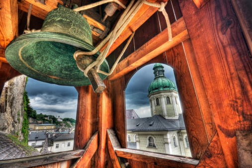 Looking out the windows of a bell tower onto an old European city. High dynamic range photo. 