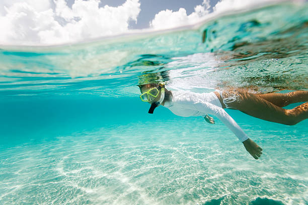 woman snorkeling in the Caribbean woman snorkeling in clear water in the Caribbean underwater diving stock pictures, royalty-free photos & images