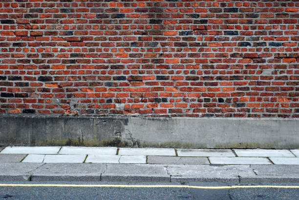 istock Urban background UK - Red brick wall with sidewalk 157428662