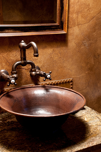 This bathroom sink gives a close up of a bowl style, antique look. 