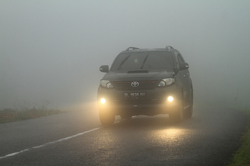 People drive on a foggy mountain road in Mount Salak, Aceh Utara, Aceh Province, Indonesia, On July 27, 2023.