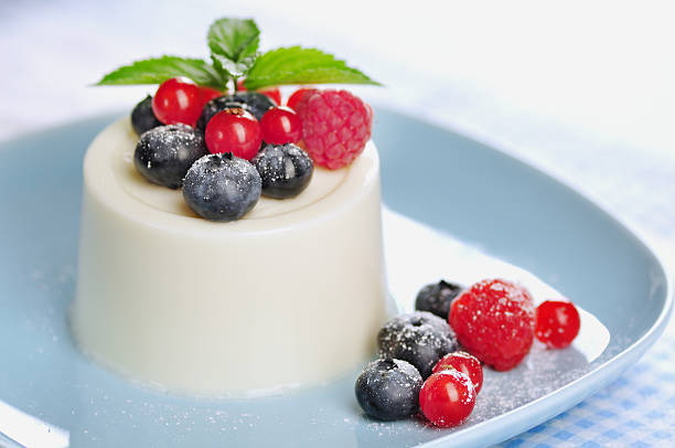 Panna cotta with berries and mint stock photo