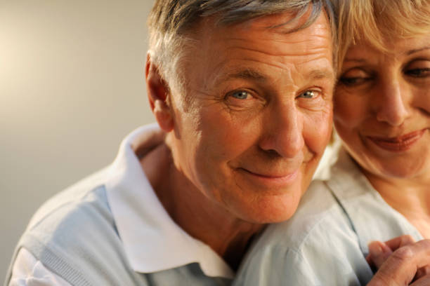 istock An older couple looking at the camera and smiling 157429182