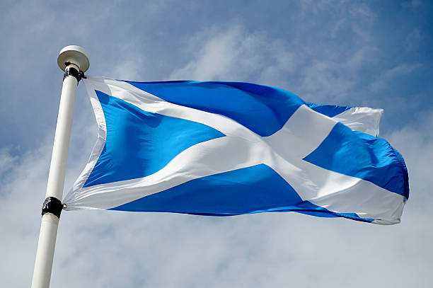 Scottish Flag in Wind A Saltire billowing in the wind. scottish flag stock pictures, royalty-free photos & images
