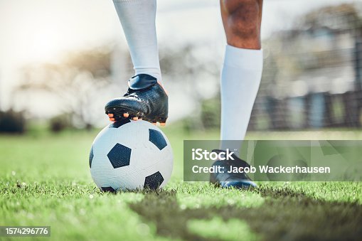 istock Legs, sports or man with a soccer ball on a field for exercise, fitness and training for a competition outdoors. Football club, ready or boots of player in a game event or match in stadium on grass 1574296776