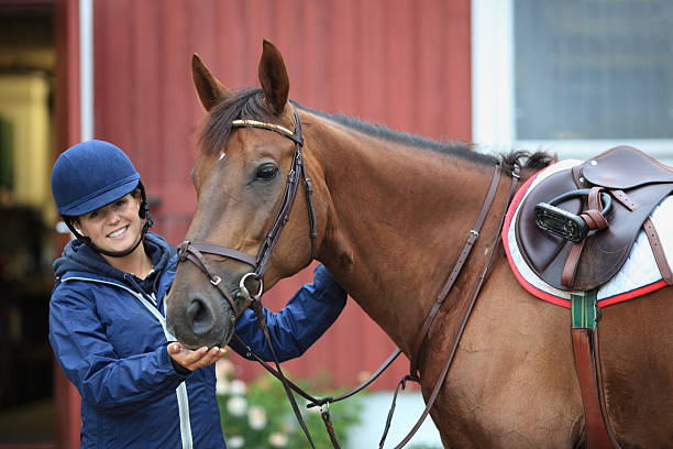 istock Teenager getting ready for horseback riding, Norway 157429758
