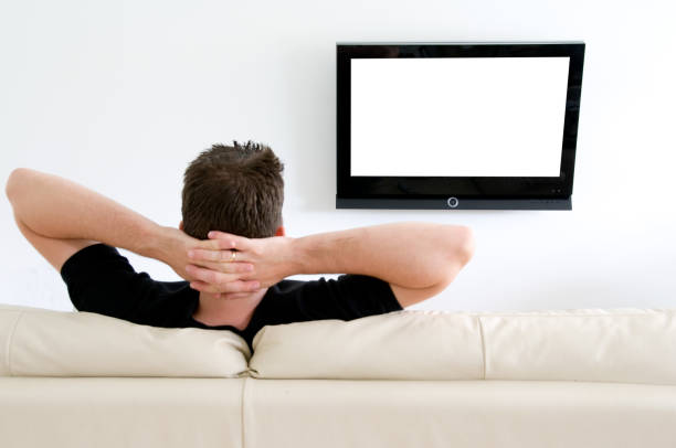 istock Relaxing and watching tv on a sofa at home 157429957