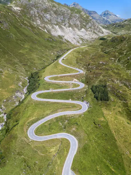 Aerial view of the winding road over the  Julier Pass in Swiss Alps mountain in summer, Canton Grison, Switzerland