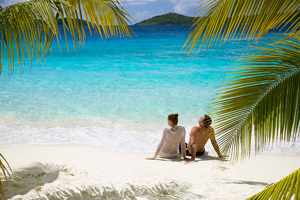 couple relaxing on the beach stock photo