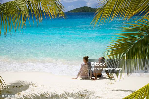 Couple Relaxing On The Beach Stock Photo - Download Image Now - Beach, Caribbean Sea, Couple - Relationship