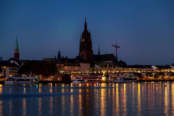 istock Frankfurt Night Skyline  with Bridge, Church Tower & River Reflections 1574302220