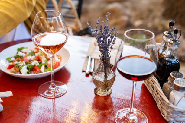 istock Glasses of rose and red wine on dinner table 1574302233