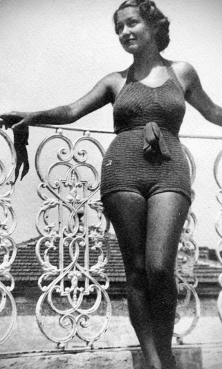 Young woman with swimwear on the balcony, added vignette.