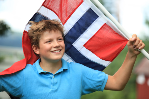 Norwegian boy patriot with flag in Oslo, Norway