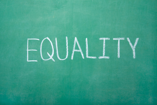Equality written on a green chalk board