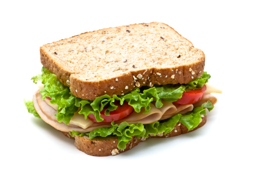 Healthy and tasty protein double sandwich for breakfast, with ham, green salad, cherry tomato and mayo, with fresh herbs, spices  and seasoning, served on a wooden cutting board, on home, bar or restaurant table, representing a healthy lifestyle and wellbeing, a close up hero image with a copy space