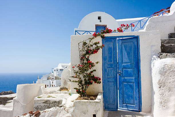 blue door and bougainvillea - santorini door sea gate bildbanksfoton och bilder