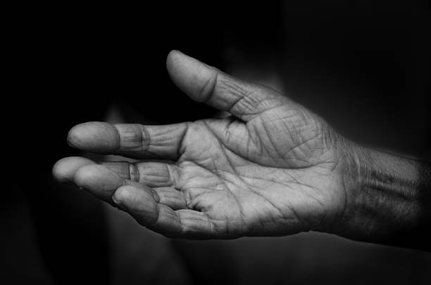 Open hand pleading for help The open hand of an elderly woman is pleading for help passing giving photos stock pictures, royalty-free photos & images