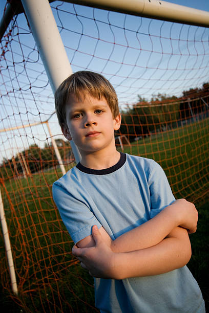 istock Child Standing in Soccer Net Boy Summer 157431714