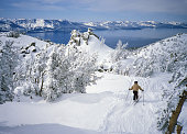 Skier in Fresh Snow Above Alpine Lake Tahoe