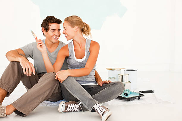 istock Young couple having fun while painting their home 157433078
