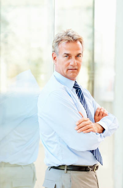 istock Confident mature businessman with arms crossed 157433122