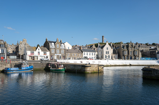 26 July 2023. Macduff,Aberdeenshire,Scotland. This is a view across the Harbour Waters towards Shore Street in Macduff on a very sunny summers day.
