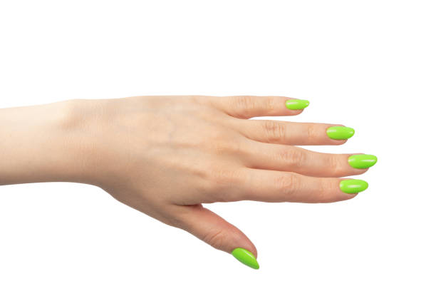 istock Hand of a woman with green naols hold some tiny or thin object. 1574335806