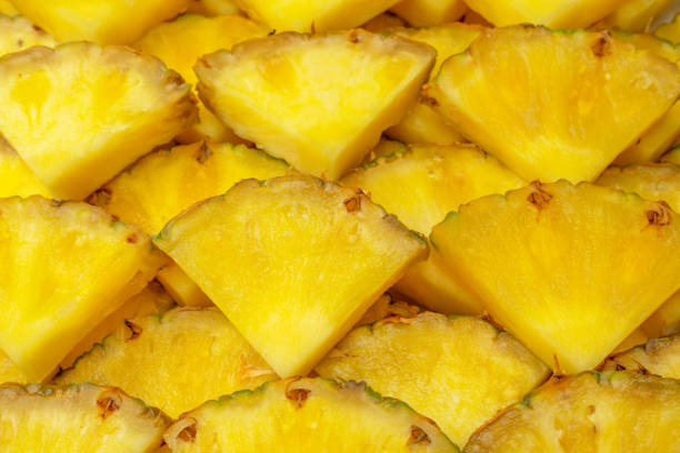 istock Pineapple juicy yellow slices as a background. 1574336156