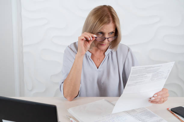 istock Senior woman working with laptop 1574336359